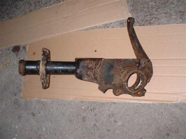 a dismantled rusty rear strut